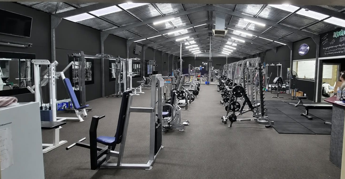Inside Robbo's Gym: rows of machines, racks and a lifting platform